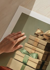 Watercolor of stacked Christmas presents with bows in green and red tones-9