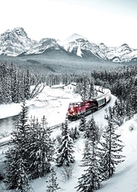 Photographic winter landscape with red train among snow-covered fir trees-7