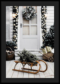 Photograph of fir tree on wooden sled in front of decorated door-4