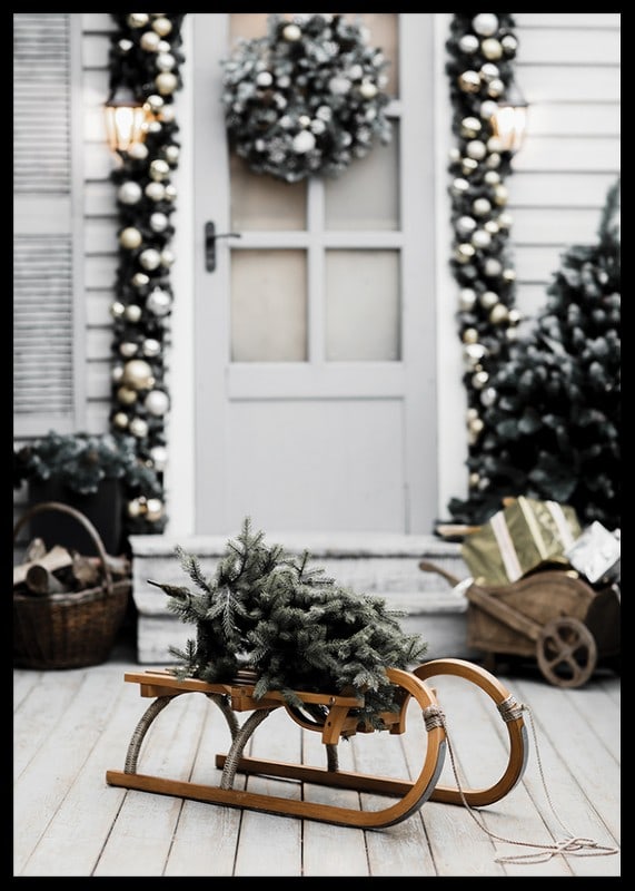 Photograph of fir tree on wooden sled in front of decorated door-12