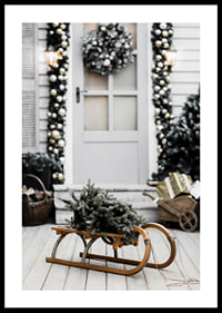 Photograph of fir tree on wooden sled in front of decorated door-0