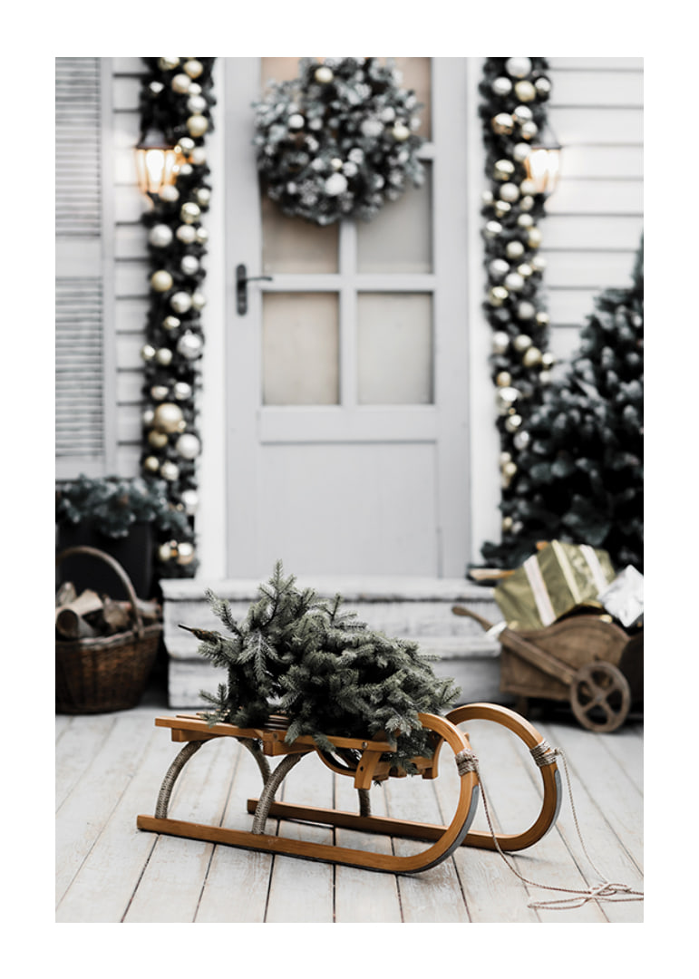 Photograph of fir tree on wooden sled in front of decorated door-12