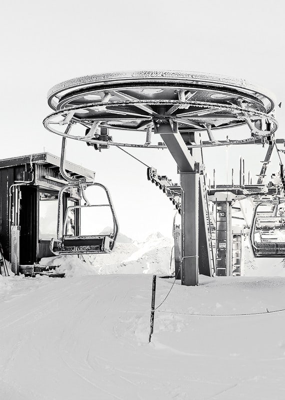 Black and white ski lift station in winter landscape with snow-covered details-12