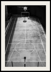 Black and white photo of empty basketball court with sharp lines and shadows-4