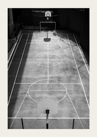 Black and white photo of empty basketball court with sharp lines and shadows-5