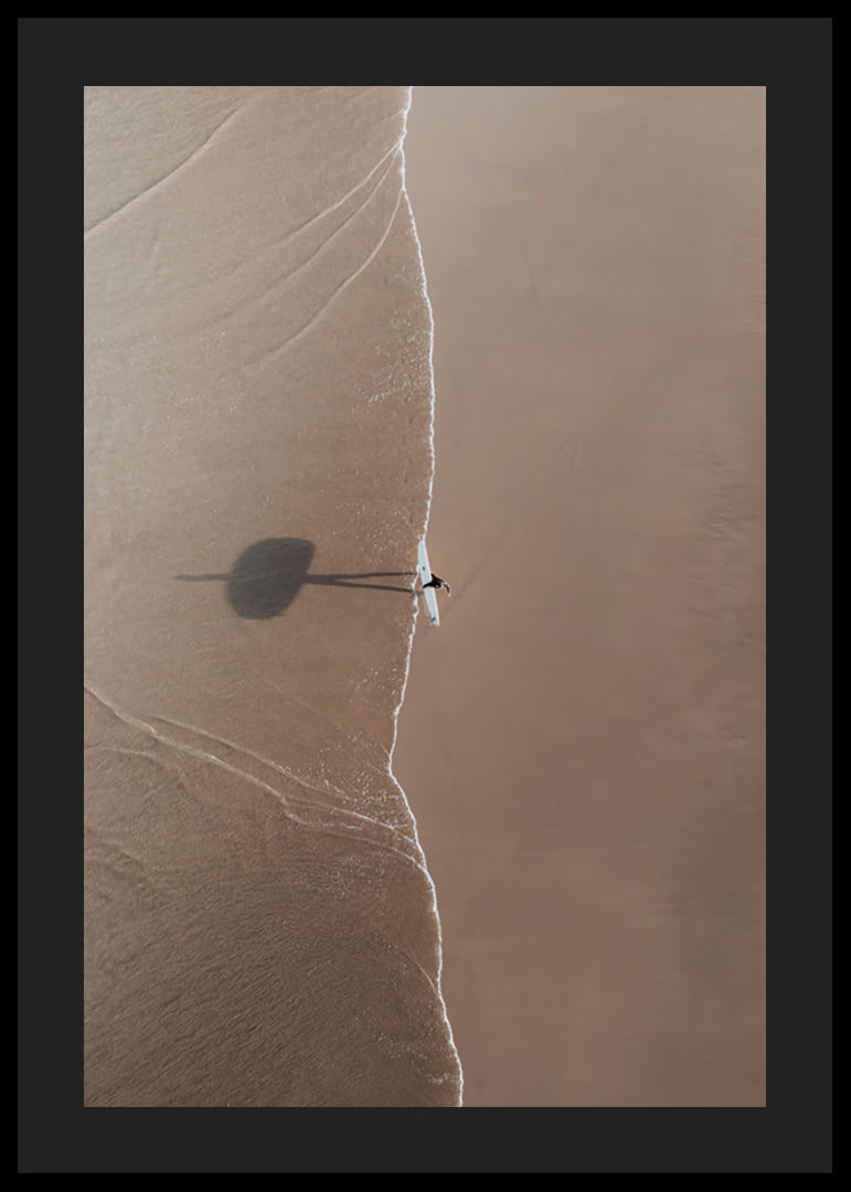 Aerial view of lone surfer with board on sandy beach-12