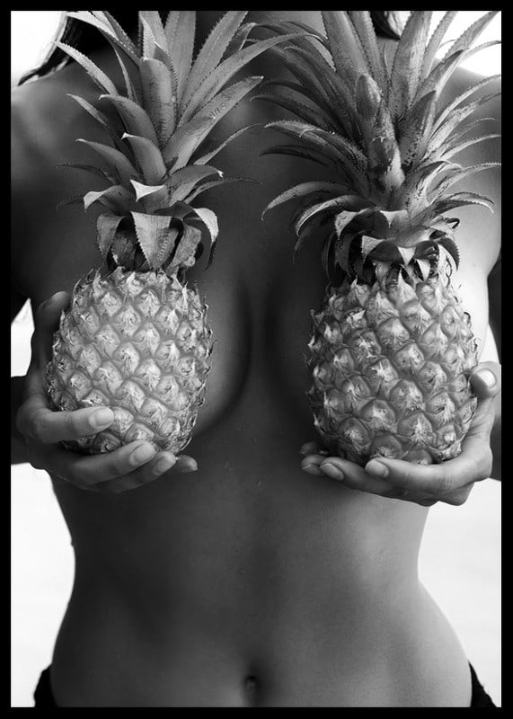 Black and white photo of woman holding two pineapples to her chest-12