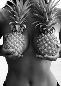 Black and white photo of woman holding two pineapples to her chest-7