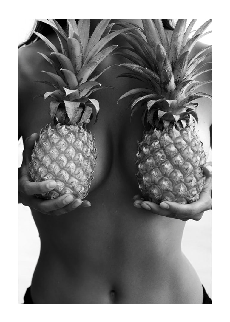 Black and white photo of woman holding two pineapples to her chest-12