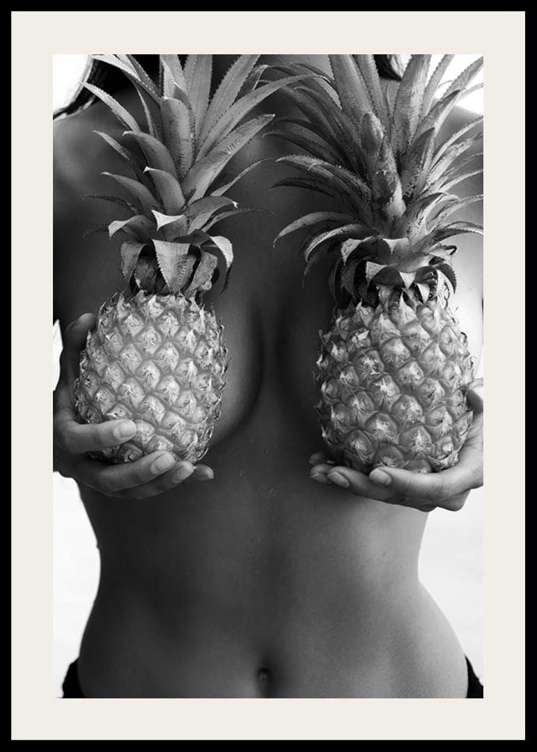Black and white photo of woman holding two pineapples to her chest-12