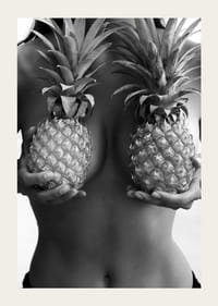 Black and white photo of woman holding two pineapples to her chest-3