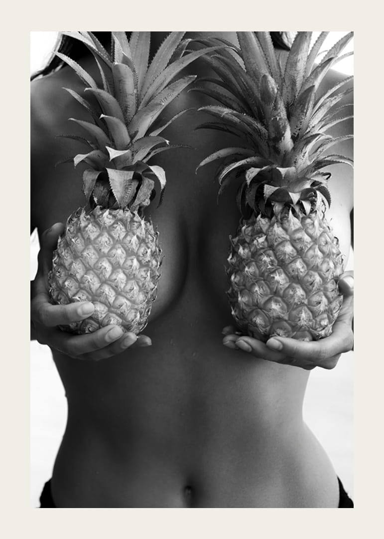 Black and white photo of woman holding two pineapples to her chest-12