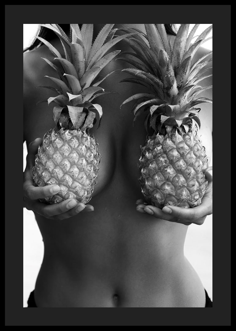 Black and white photo of woman holding two pineapples to her chest-12
