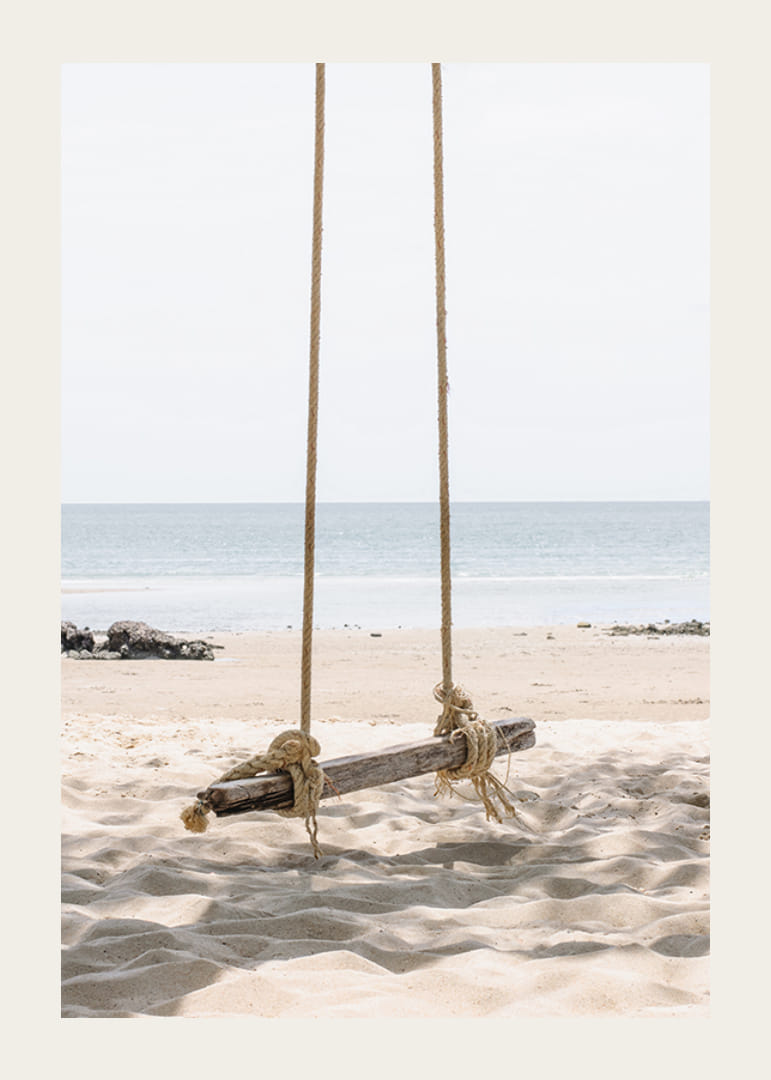 Photograph of wooden swing on light sandy beach by the sea-12
