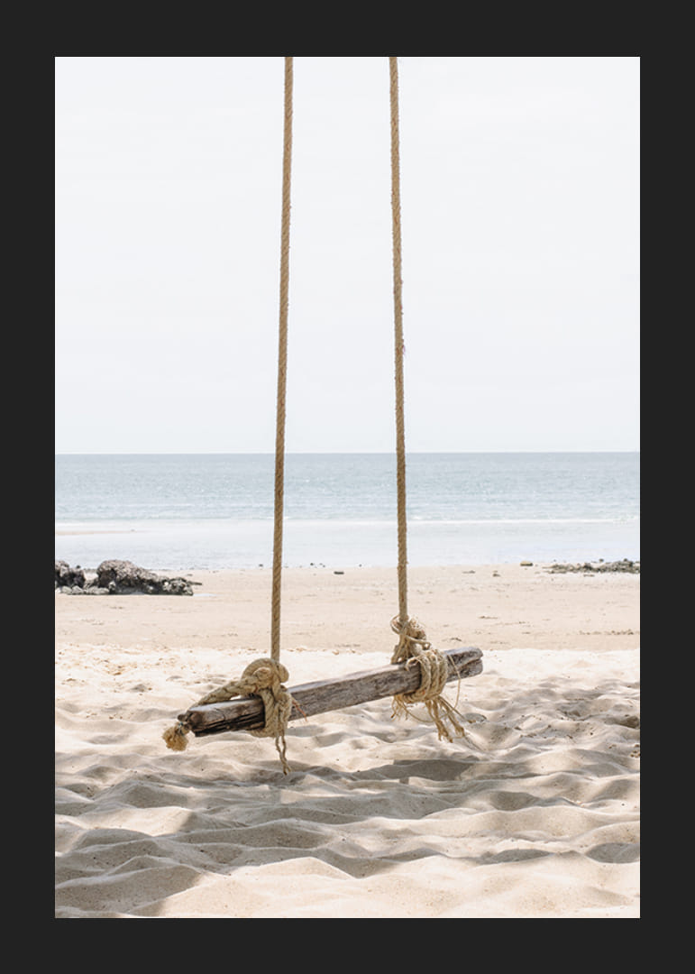 Photograph of wooden swing on light sandy beach by the sea-12
