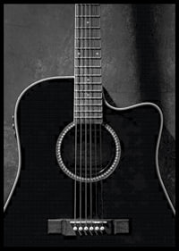 Black and white close-up of acoustic guitar against concrete background-6