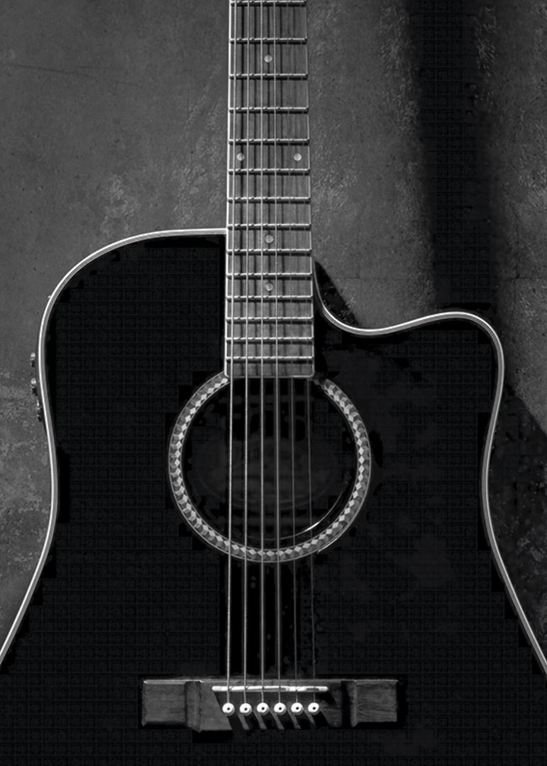 Black and white close-up of acoustic guitar against concrete background-12