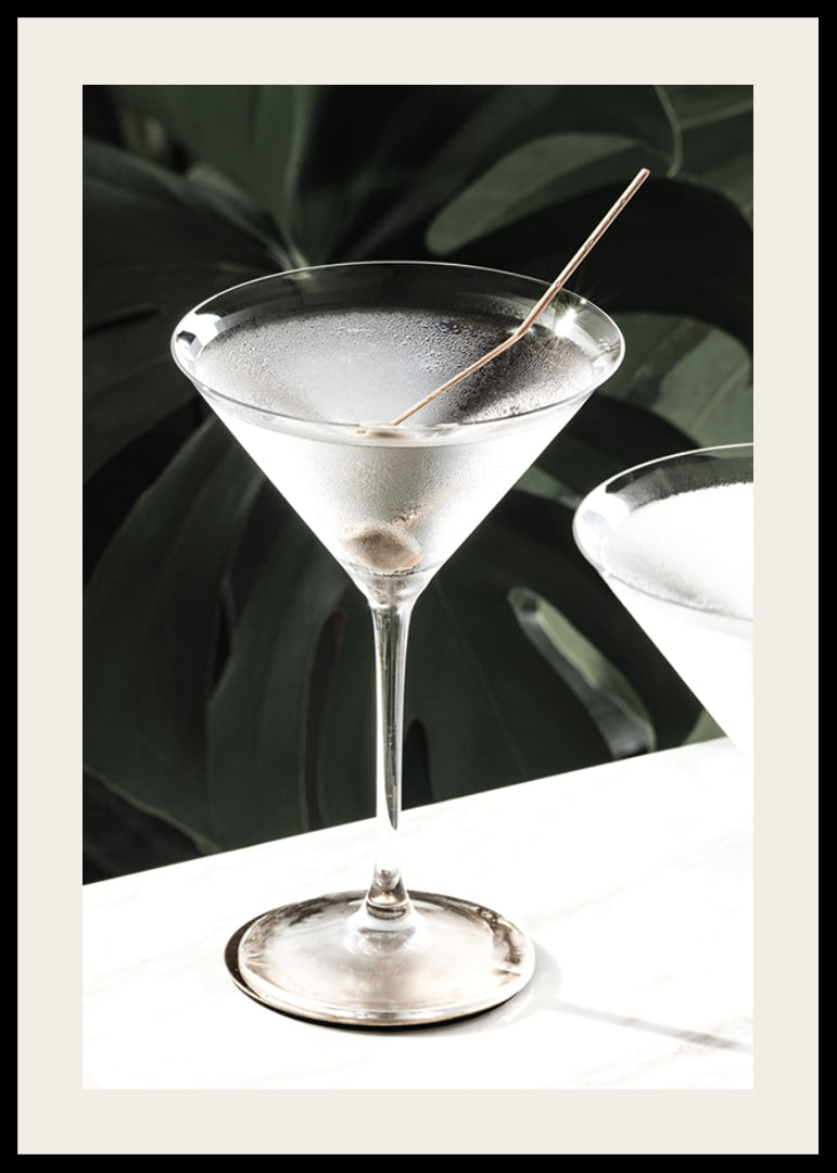 Photographic close-up of martini glass with olive and iced surface-12