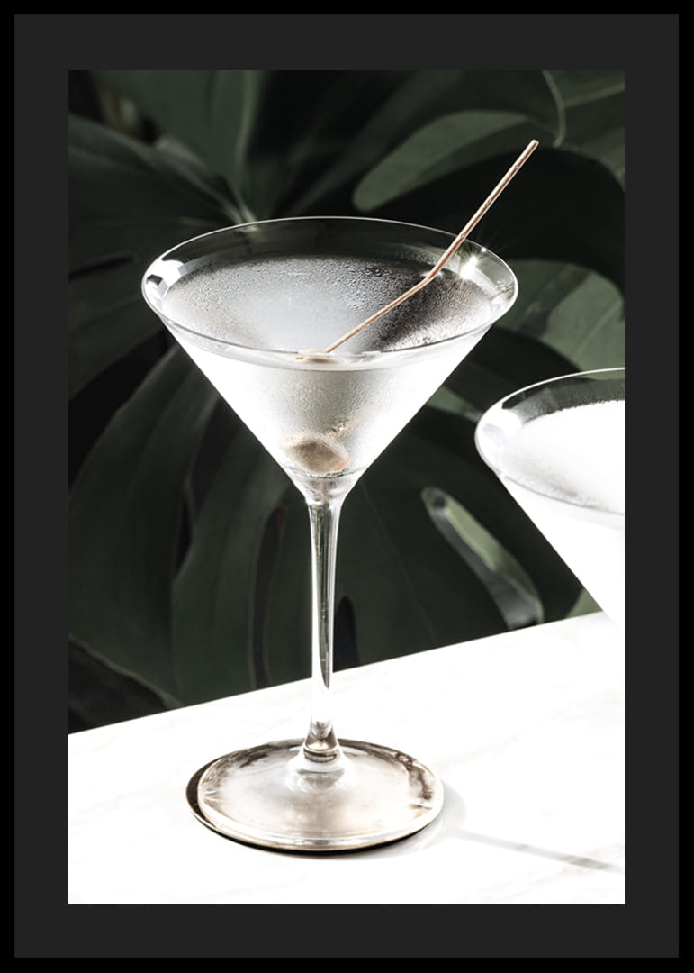 Photographic close-up of martini glass with olive and iced surface-12