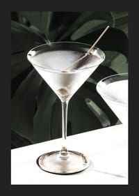 Photographic close-up of martini glass with olive and iced surface-5