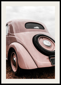 Photograph of classic pink vintage car in grass, rear view-2