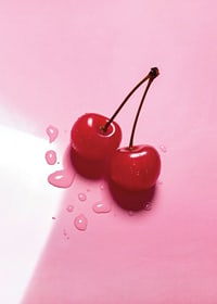 Two red cocktail berries with stems on glossy pink surface-7