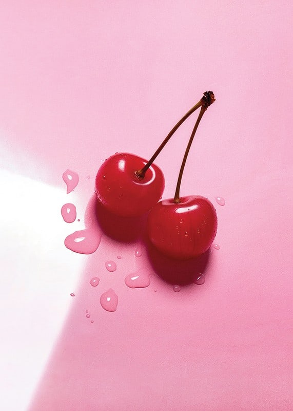 Two red cocktail berries with stems on glossy pink surface-12