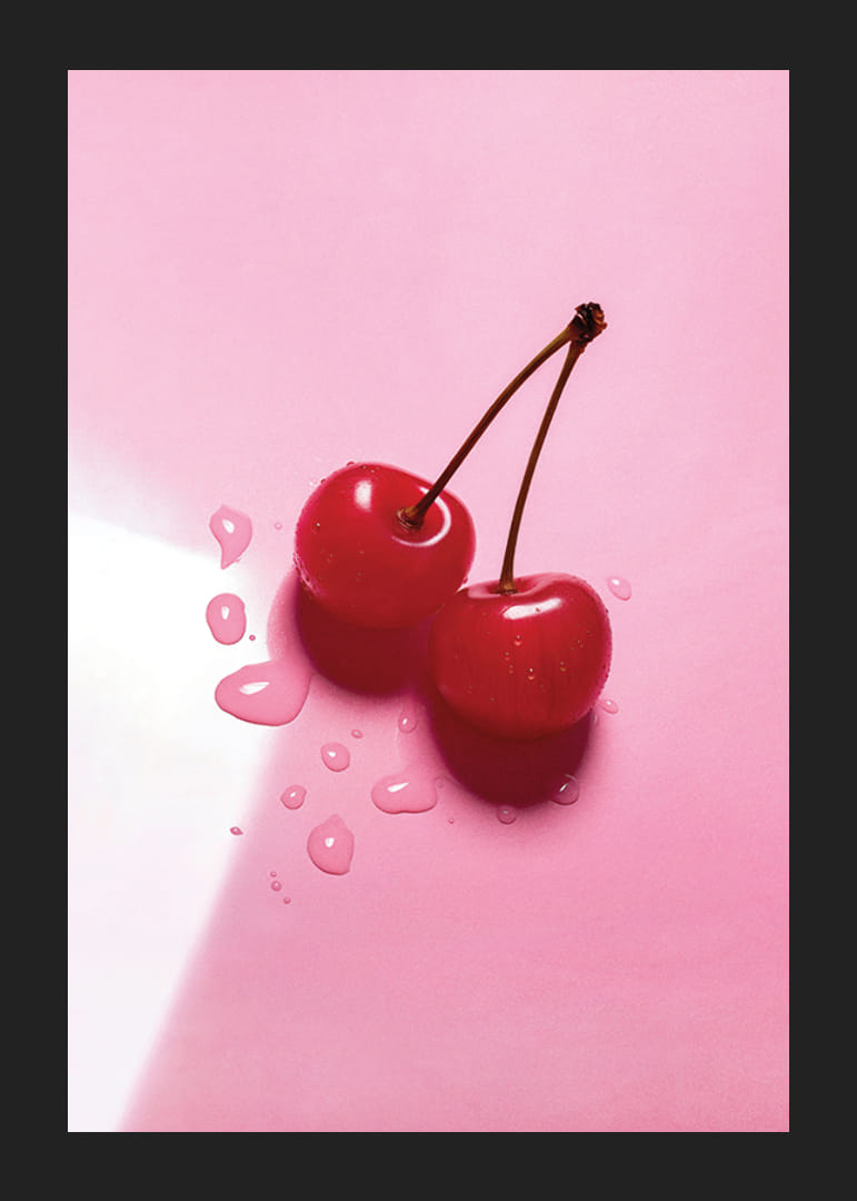 Två röda cocktailbär med stjälkar på blank rosa yta-12