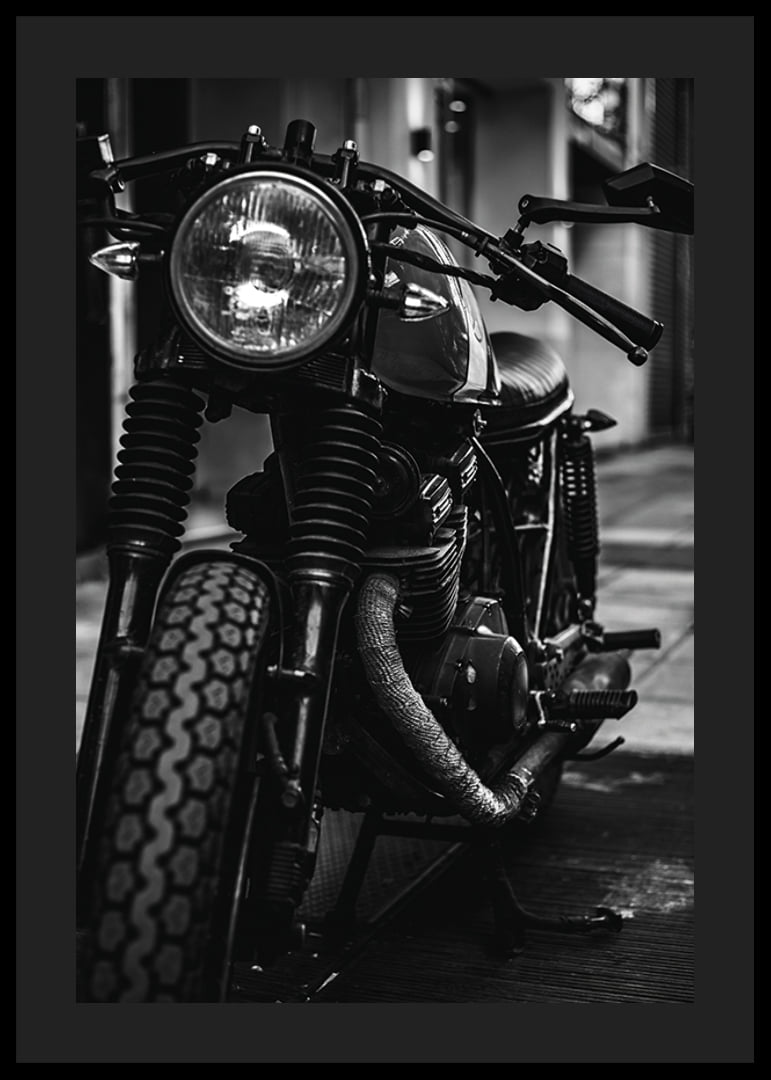Black and white close-up of classic motorcycle in urban environment-12