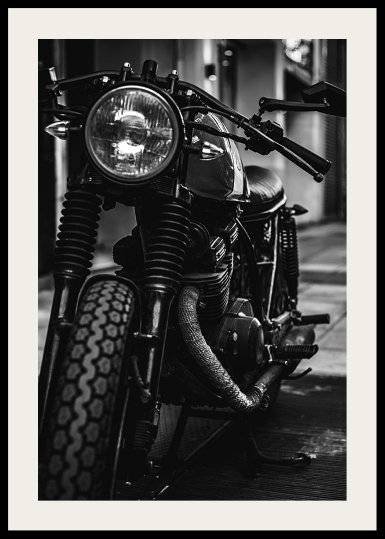 Black and white close-up of classic motorcycle in urban environment-12