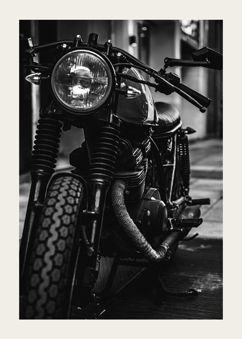 Black and white close-up of classic motorcycle in urban environment-12