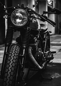 Black and white close-up of classic motorcycle in urban environment-7