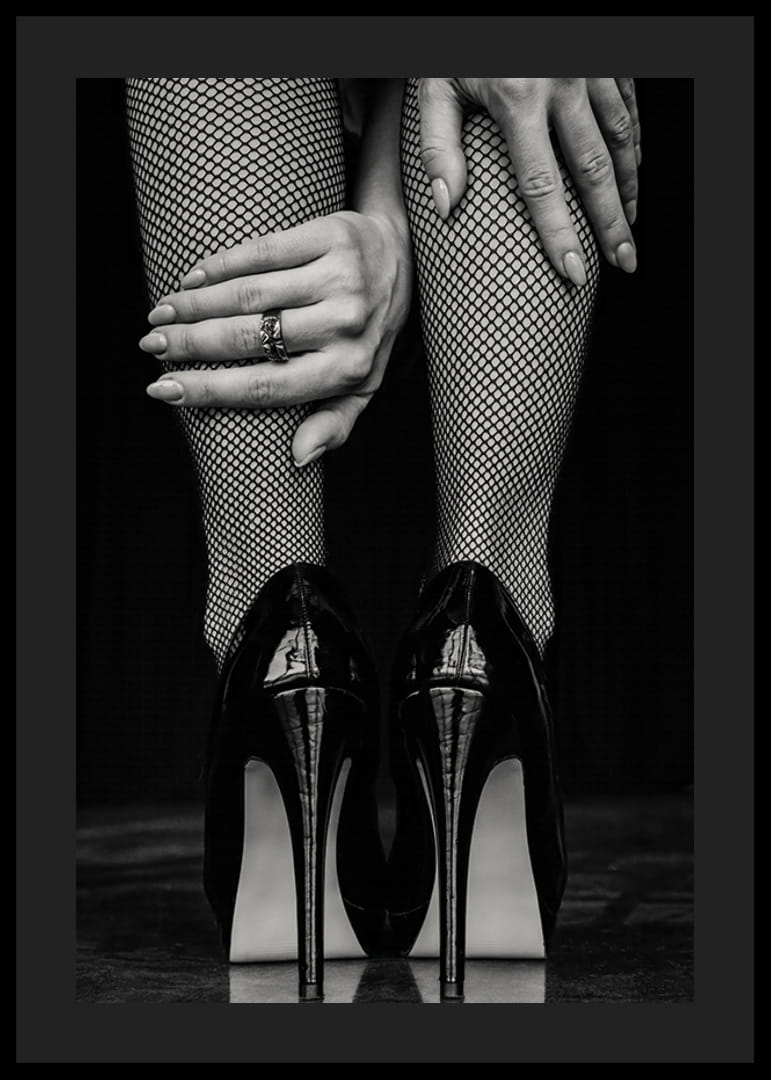 Black and white photo of legs in fishnet tights and black heels-12