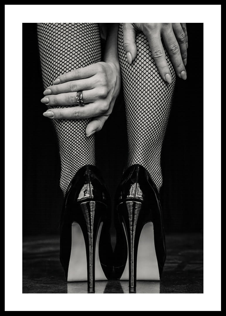 Black and white photo of legs in fishnet tights and black heels-12