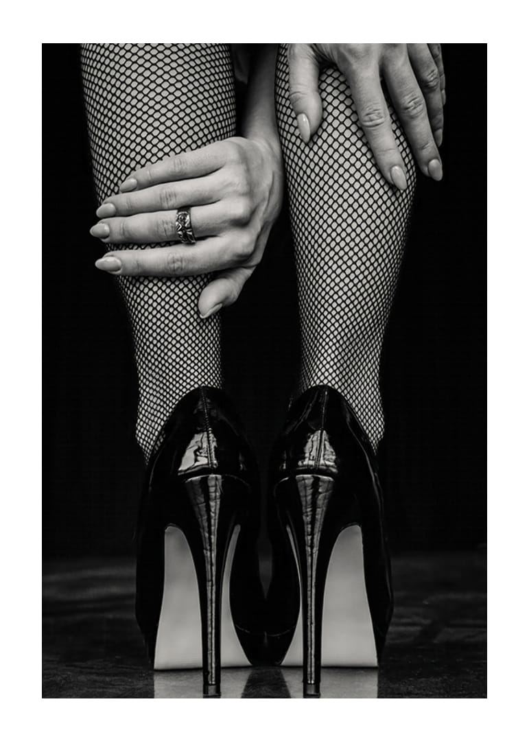 Black and white photo of legs in fishnet tights and black heels-12
