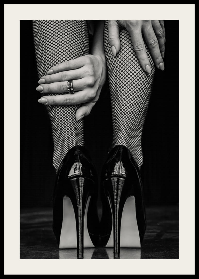 Black and white photo of legs in fishnet tights and black heels-12
