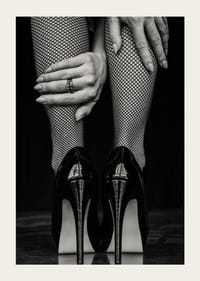 Black and white photo of legs in fishnet tights and black heels-5