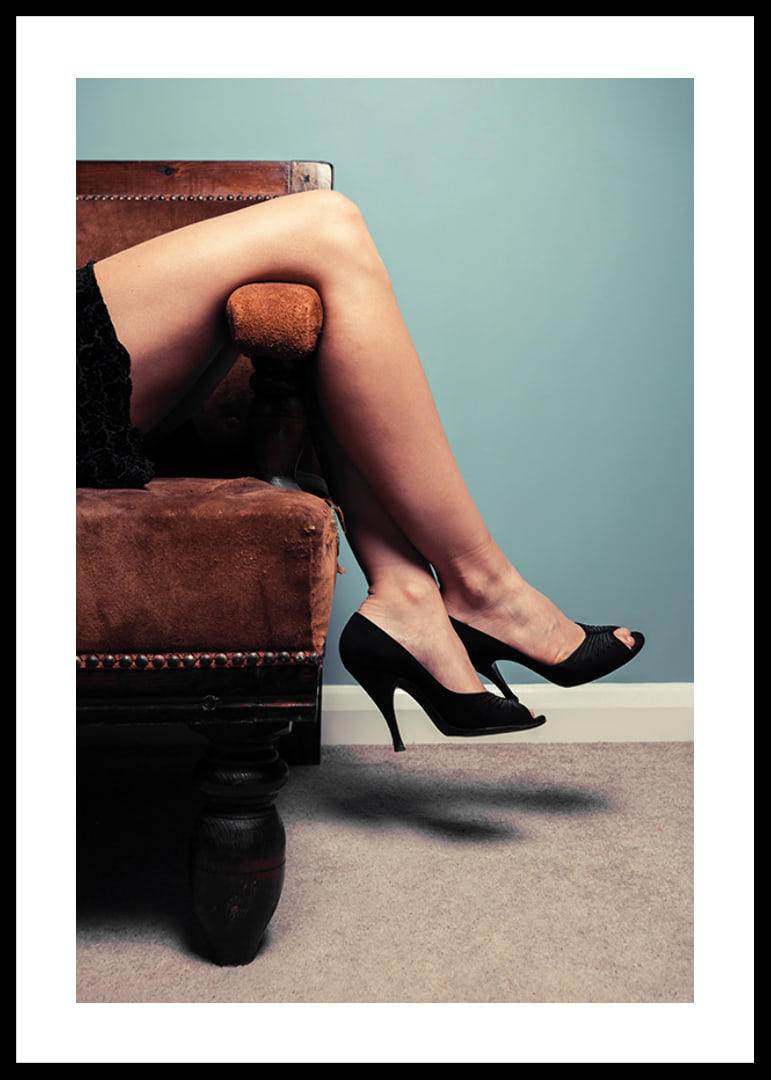 Photographic close-up of woman in high heels on sofa-12