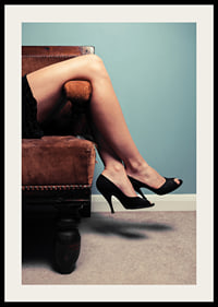 Photographic close-up of woman in high heels on sofa-2
