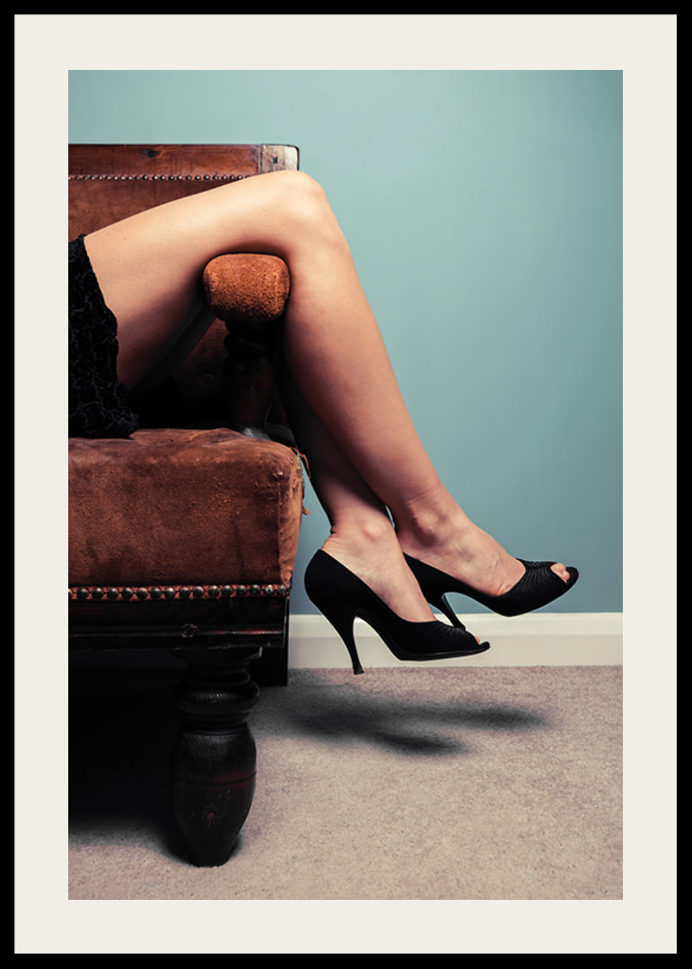 Photographic close-up of woman in high heels on sofa-12