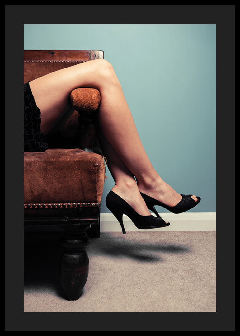 Photographic close-up of woman in high heels on sofa-12
