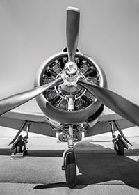 Black and white photograph of old propeller plane from the front-7