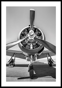 Black and white photograph of old propeller plane from the front-0