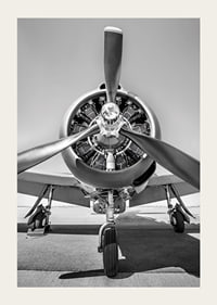 Black and white photograph of old propeller plane from the front-3