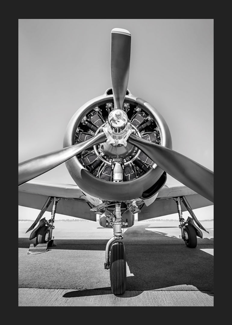 Black and white photograph of old propeller plane from the front-12