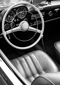 Black and white close-up of classic car interior with steering wheel-7
