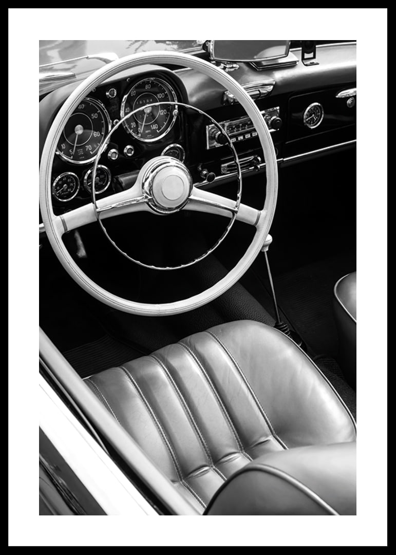 Black and white close-up of classic car interior with steering wheel-12