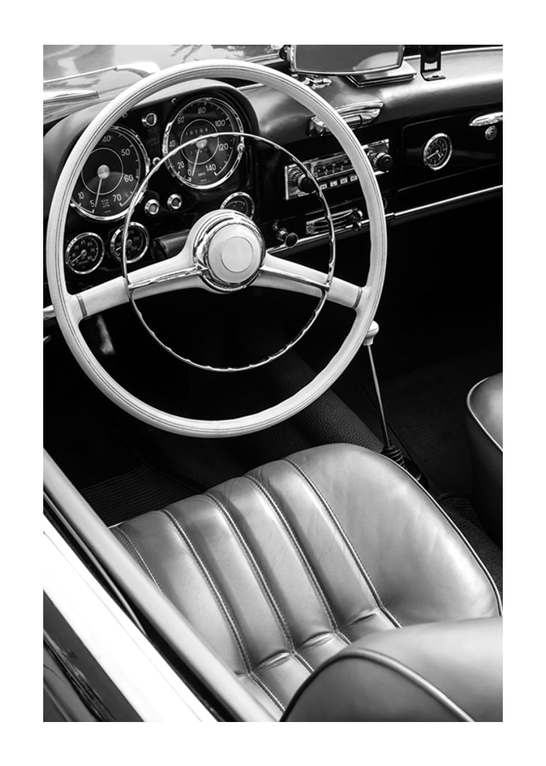 Black and white close-up of classic car interior with steering wheel-12