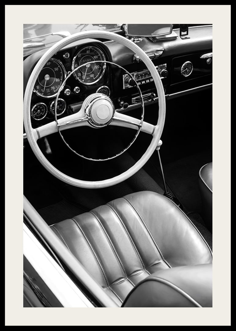 Black and white close-up of classic car interior with steering wheel-12