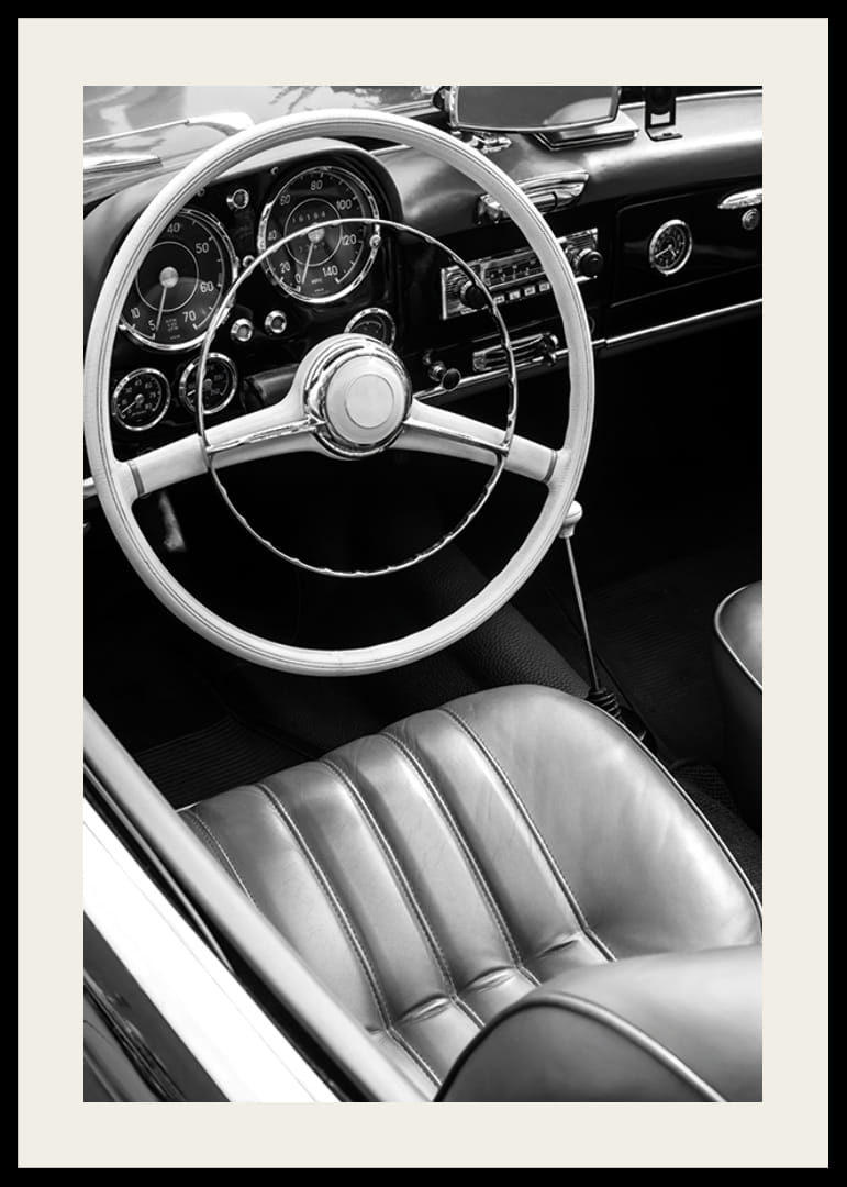 Black and white close-up of classic car interior with steering wheel-12